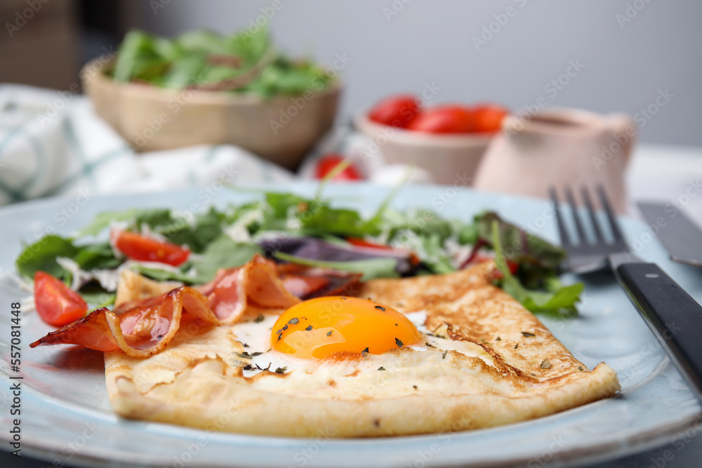 Delicious crepe with egg on table, closeup. Breton galette Delicious crepe with egg on table, closeup. Breton galette