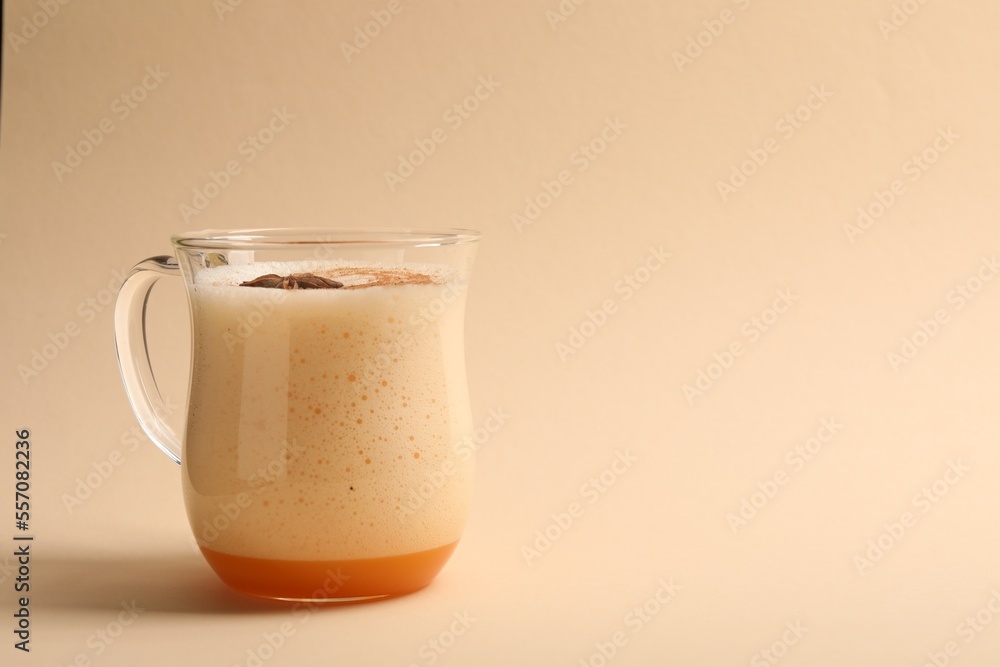 Delicious eggnog with anise on beige background. Space for text Delicious eggnog with anise on beige background. Space for text