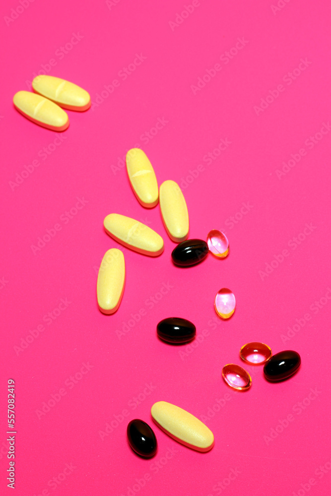 Vitamins on Pink background