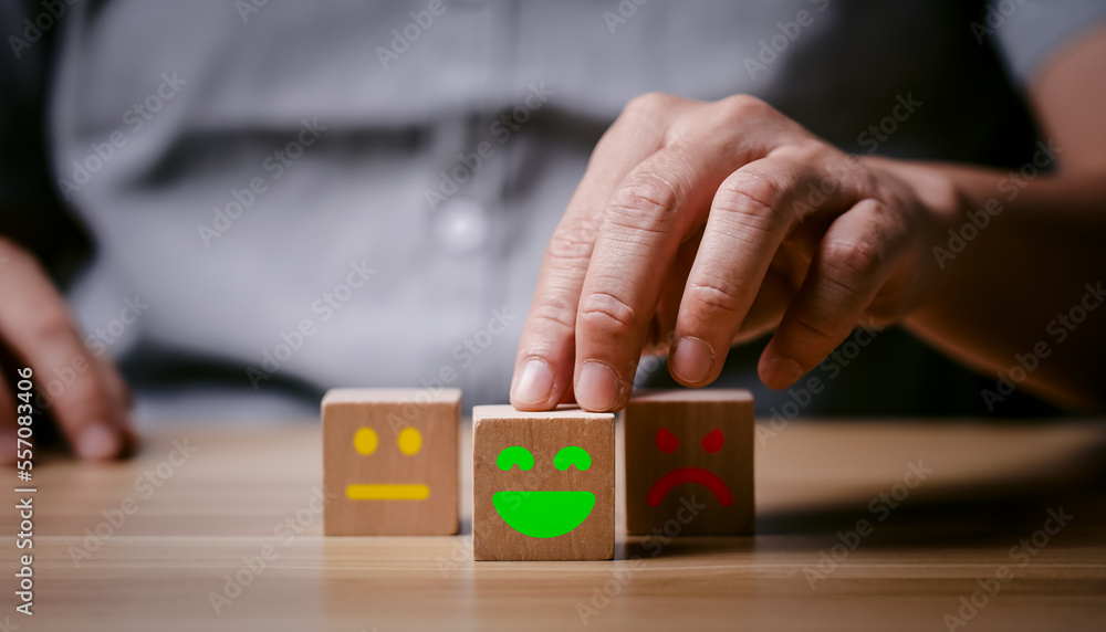 Hand of a businessman chooses a smiley face on wood block. 5 Star Satisfaction. customer services best excellent business rating experience. Satisfaction survey concept. give rating Hand of a businessman chooses a smiley face on wood block. 5 Star Satisfaction. customer services best excellent business rating experience. Satisfaction survey concept. give rating