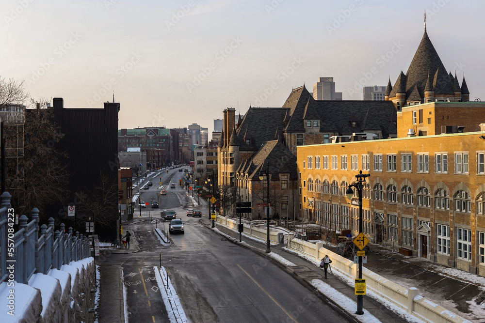 Fototapeta premium Streets of Montreal in winter. The historical part of the city - old houses, shops, cafes, people walking, cars, public transport works. Christmas time