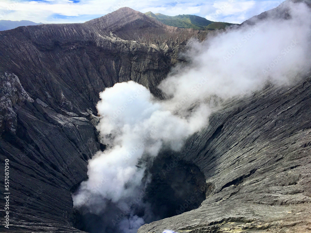 On top of a volcano shooting white smoke