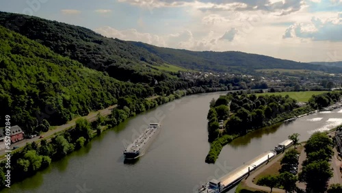 Inland shipping vessel gas transport over the river Mosel in Germany on a bright summer day in the mountains of Bernkastel. Gas tanker vessel at the river Moselle photo