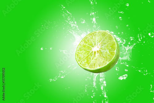 Lemon splash on green background. Green lime splashing.