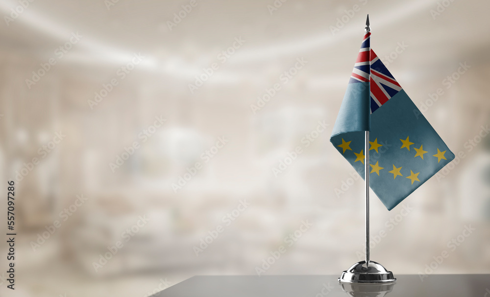 Fototapeta premium A small Tuvalu flag on an abstract blurry background