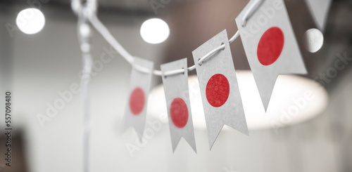 A garland of Japan national flags on an abstract blurred background