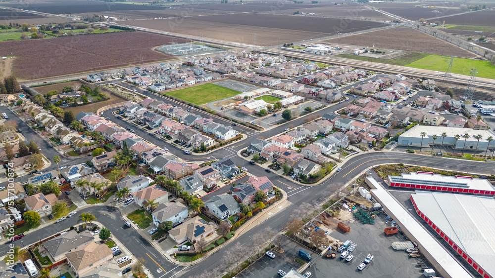 Top Down aerial photos over a community in California with homes with solar panels and roadways and parks