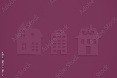 Real estate agency. Flat wooden houses on red background view from above. Concept of a creative real estate agency, individual selection of housing.