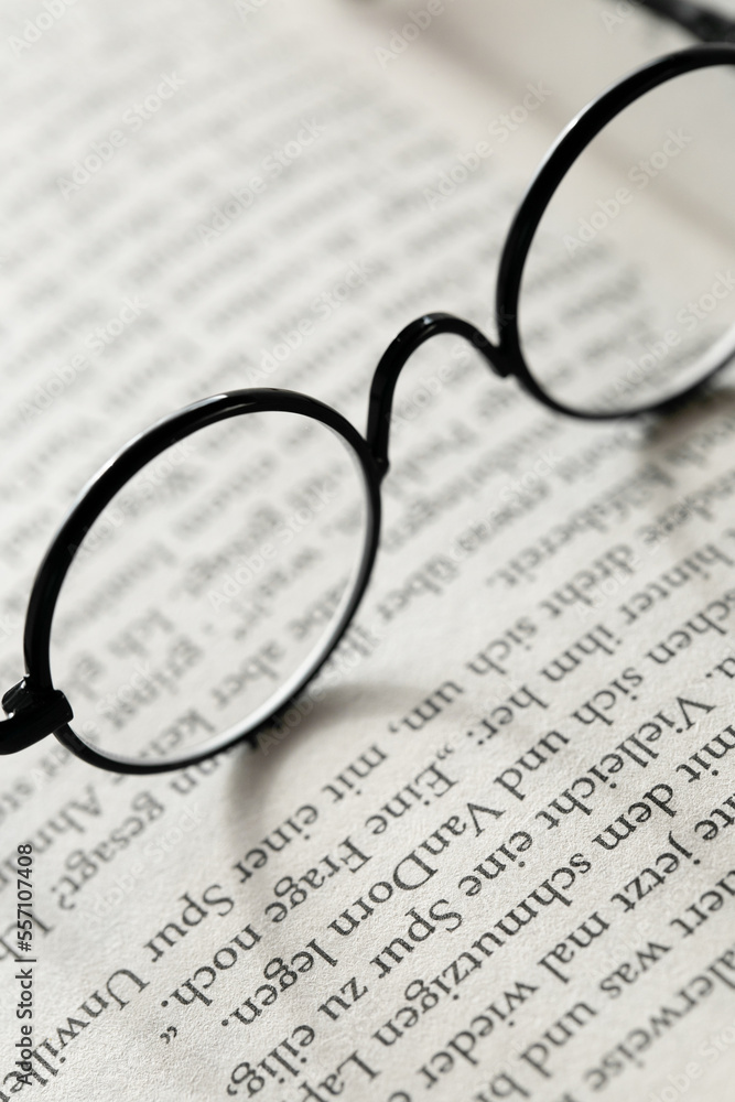 Education and schooling concept.Reading glasses close-up on the pages of a book .Symbol of study, knowledge and reading. Education and schooling concept.Reading glasses close-up on the pages of a book .Symbol of study, knowledge and reading.