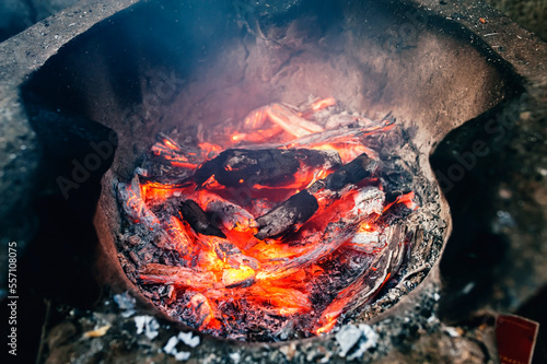 Image of charcoal being burned in an ancient clay oven
