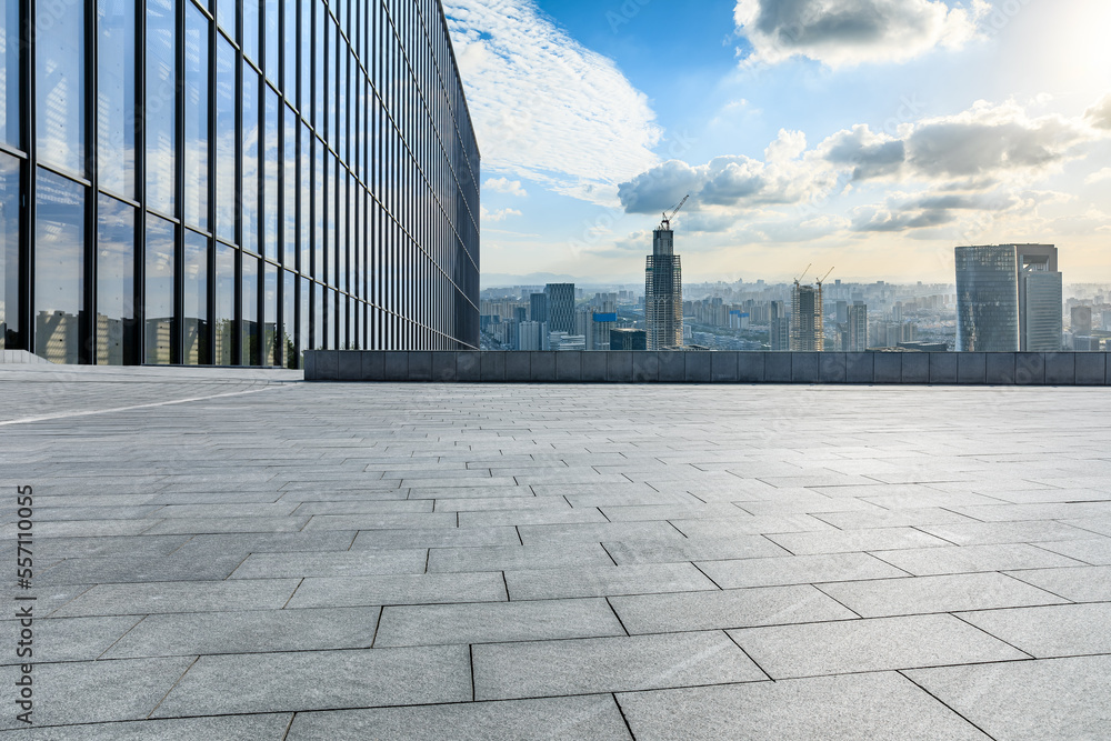 Empty square floor and modern city skyline with buildings at sunset in Ningbo, Zhejiang Province, China.