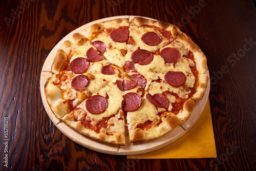 salami pizza on a wooden table