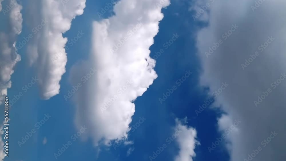 Seamless loop of fluffy clouds in a blue sky in a summer shot on a clear day. Looping background video. Vertical Footage. Seamless loop of fluffy clouds in a blue sky in a summer shot on a clear day. Looping background video. Vertical Footage.