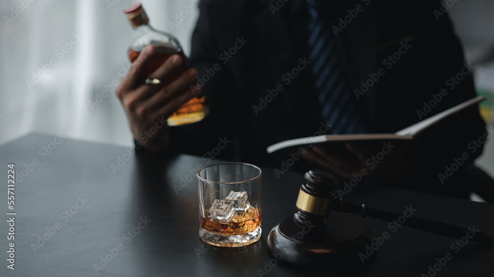 A lawyer holding a glass of whiskey, He's in his office, and he's stressing about arguing for a client, he's a lawyer. The concept of clear legal litigation.