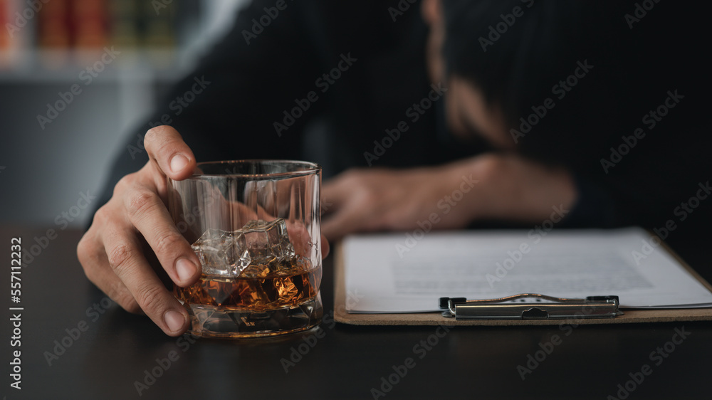A lawyer holding a glass of whiskey, He's in his office, and he's stressing about arguing for a client, he's a lawyer. The concept of clear legal litigation.