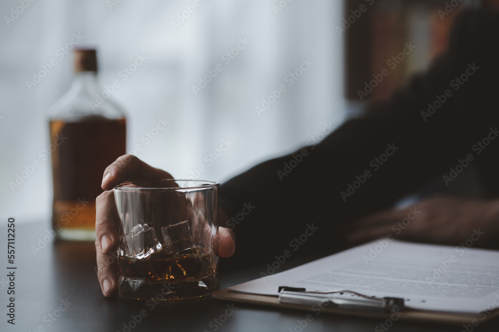 A lawyer holding a glass of whiskey, He's in his office, and he's stressing about arguing for a client, he's a lawyer. The concept of clear legal litigation. A lawyer holding a glass of whiskey, He's in his office, and he's stressing about arguing for a client, he's a lawyer. The concept of clear legal litigation.