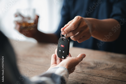 Photos Man holding a glass of brandy, he is drinking brandy in a bar, drinking alcohol impairs driving ability and can damage health