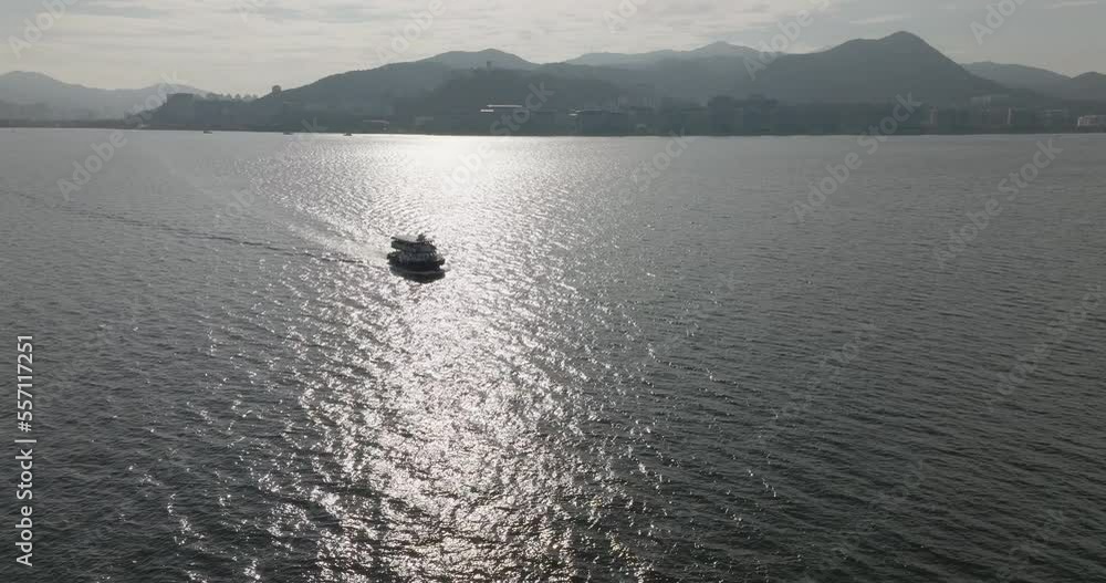 Drone shot of tourism Boat on the watery in the city in Hong Kong, China Drone shot of tourism Boat on the watery in the city in Hong Kong, China