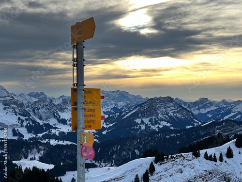 Hiking markings and orientation signs with signposts for navigating in the idyllic winter ambience on the Alpstein mountain massif and in the Swiss Alps, Urnäsch (Urnaesch or Urnasch) - Switzerland photo