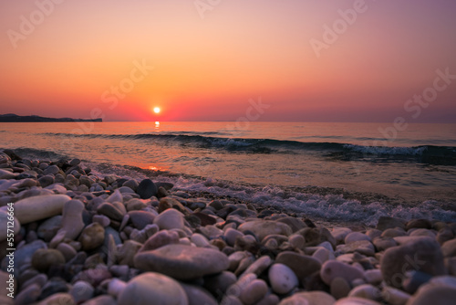 Late sunset over wavy sea on Acharavi Beach, Corfu