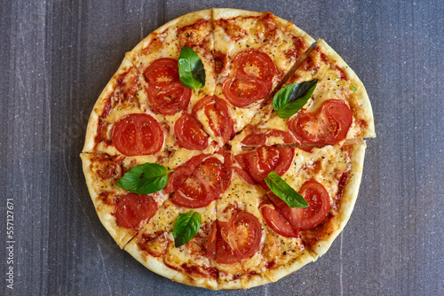 pizza with tomatoes and mint on a marble background
