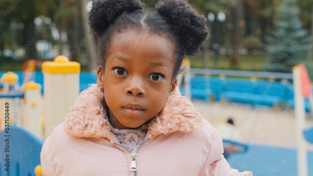 Close up serious child face portrait cute little African American