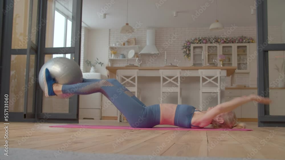 Active charming sporty fit mature female working out stability ball v