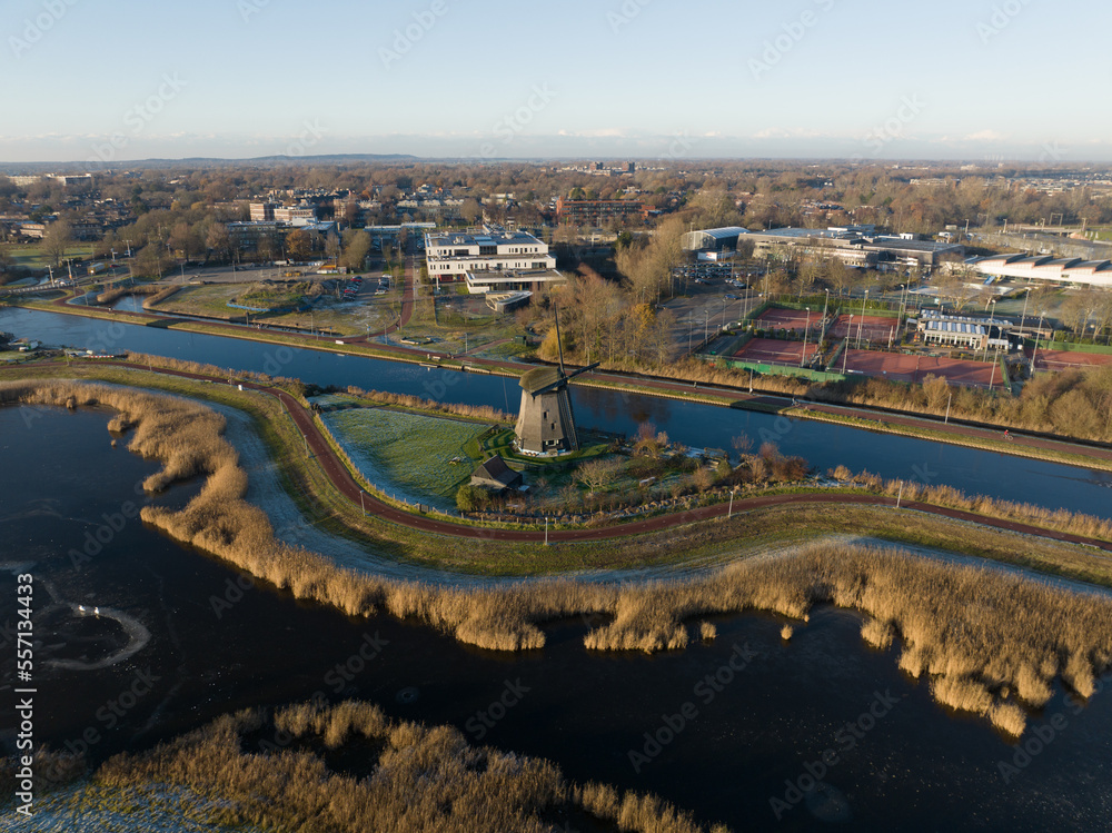 Strijkmolen E, Ouddorp, Alkmaar, North Holland,The Netherlands. Oak octagonal polder mill from 1630. Ironing mills do not drain polders, grind the water from one reservoir to the other. Winter aerial.
