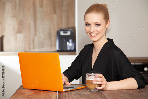 Attractive blonde student girl working on the laptop