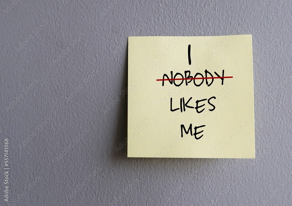 Copy space wall with stick note written NOBODY LIKES ME (replace NOBODY