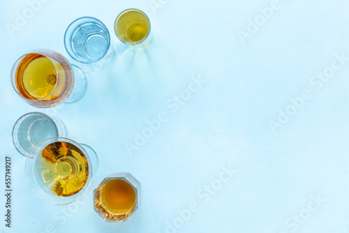 Alcohol in glasses with ice. Strong alcoholic drinks background