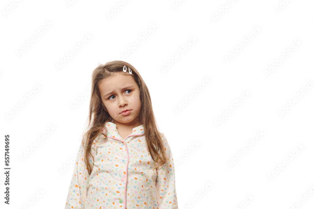 Upset baby girl in pajamas, feeling loneliness while woke up, expressing worried emotion and sadness, looking aside at a copy space for your advertising, standing isolated over white background Upset baby girl in pajamas, feeling loneliness while woke up, expressing worried emotion and sadness, looking aside at a copy space for your advertising, standing isolated over white background