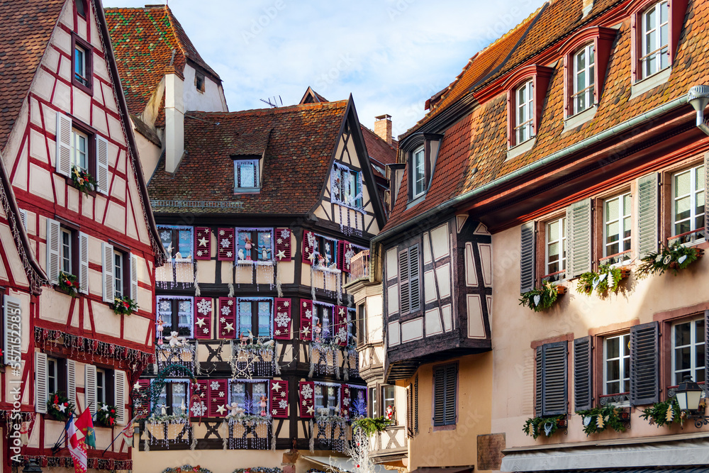 Christmas holidays on the streets of picturesque Colmar, Alsace. Bright colorful facades of traditional fairy-tale houses in Christmas attire