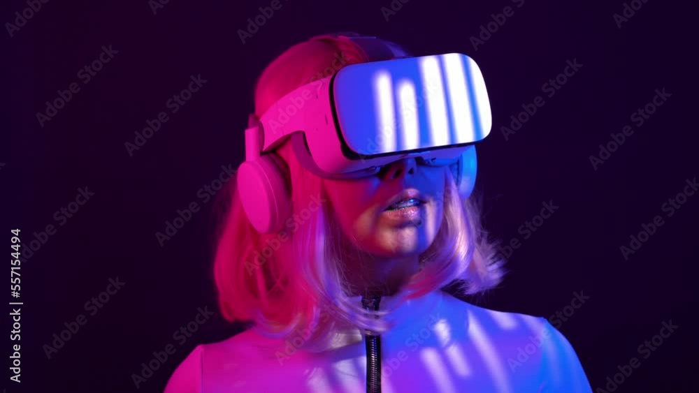 Woman in virtual reality goggle in neon colors. Woman in virtual reality goggle in neon colors.
