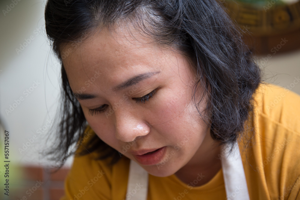 Close up hand of Asian Female using pottery wheel to make a tea pot in the workshop Close up hand of Asian Female using pottery wheel to make a tea pot in the workshop