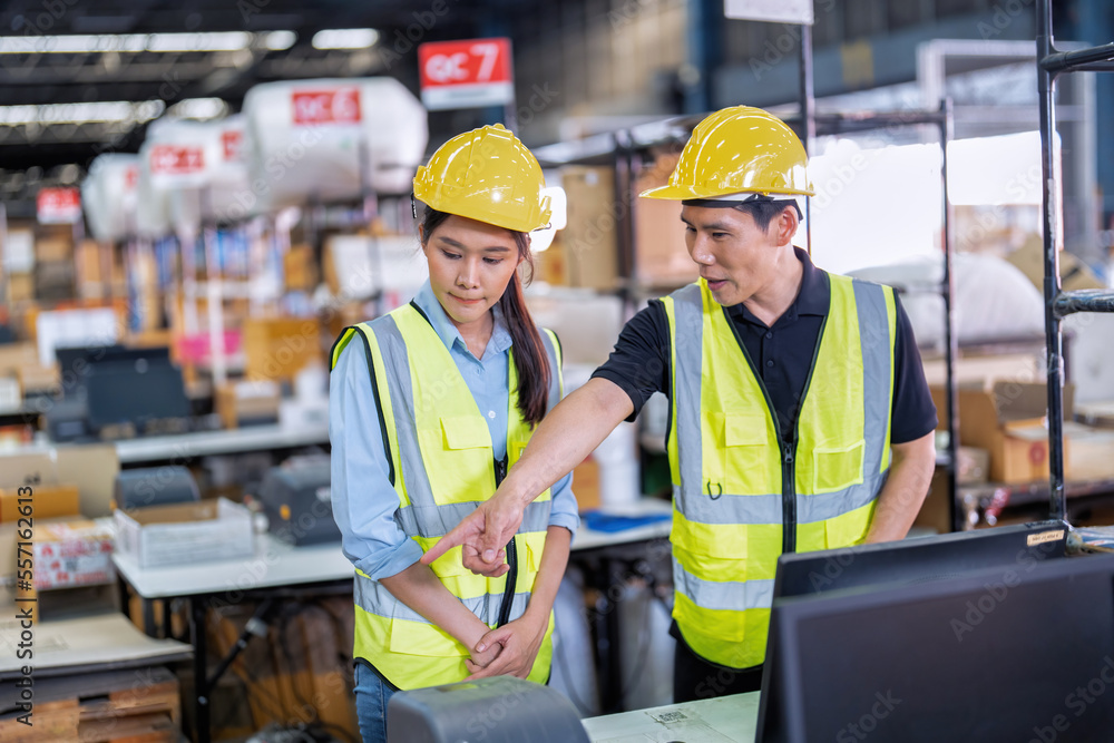 Staff working in large depot storage warehouse trainee check packing box and scan at cashier counter Staff working in large depot storage warehouse trainee check packing box and scan at cashier counter