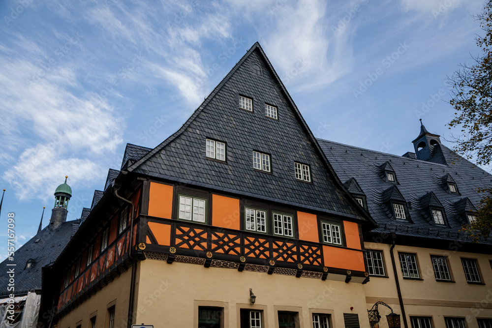 Wernigerode, Saxony-Anhalt, Germany, 29 October 2022:  Historic townhall or Rathaus in Market Square, vintage colored timber framed building Fachwerkbau, half-timbered home at sunny autumn day