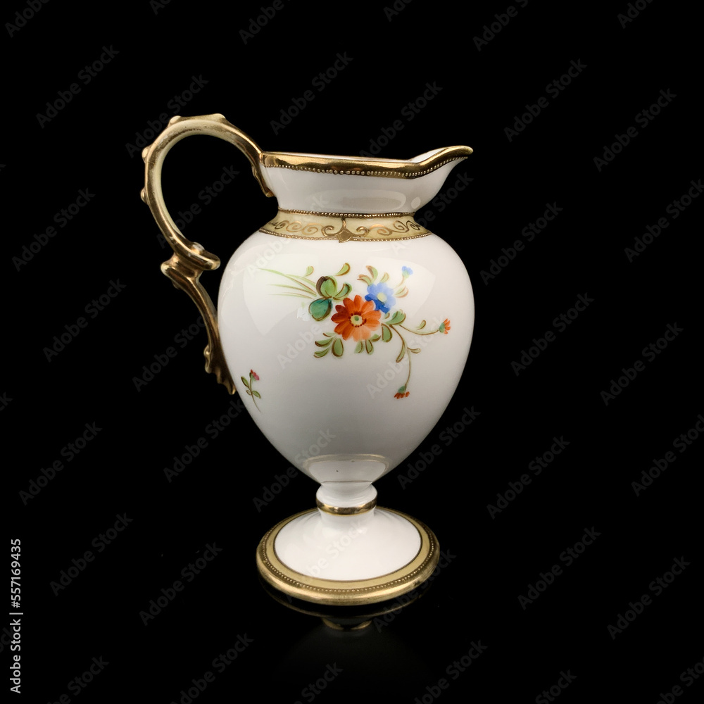 vintage milk jug with floral pattern. antique tea service.
