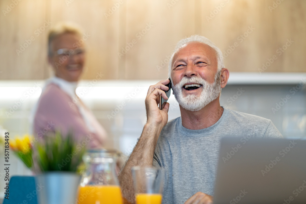 Smiling senior man working from home Smiling senior man working from home