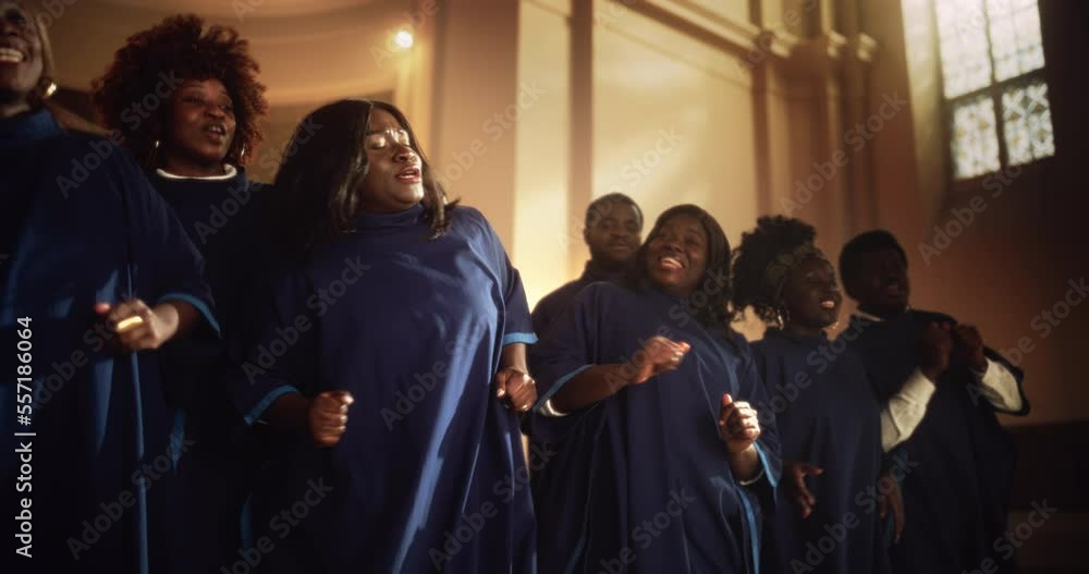 Black Christian Gospel Singers in Church Clapping and Stomping, Praising Lord Jesus Christ. Warm Atmosphere in Church Thanks to Energetic Choir Singing Uplifting Music with Emotions and Happiness