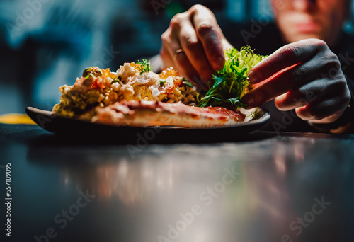 chef decorated plate with food on kitchen