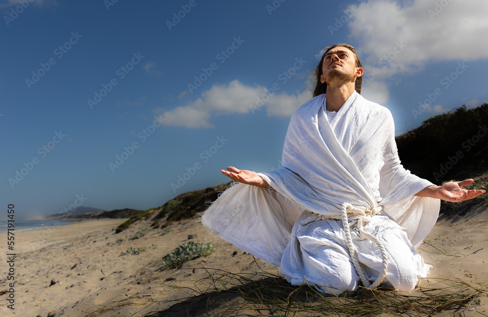 Man kneeling looking up at heavenly sky in praise