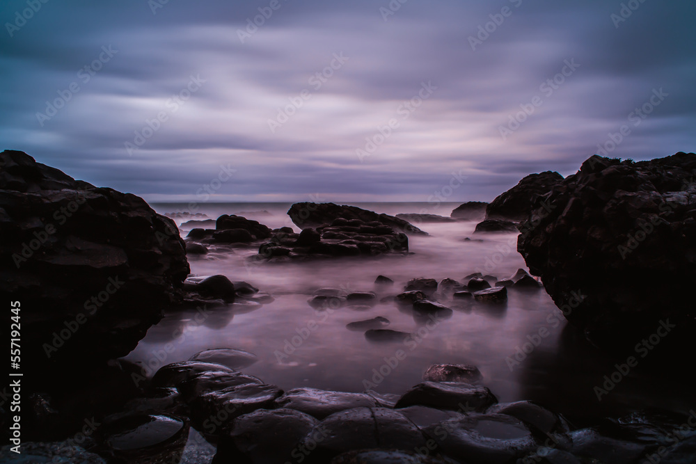 long exposure of a rocky coast, cloudy sky