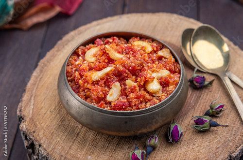 Gajar ka halwa is, Popular Indian dessert pudding made with grated carrots, milk, sugar and nuts served hot with a garnish of almonds, cashew nuts and pistachios.