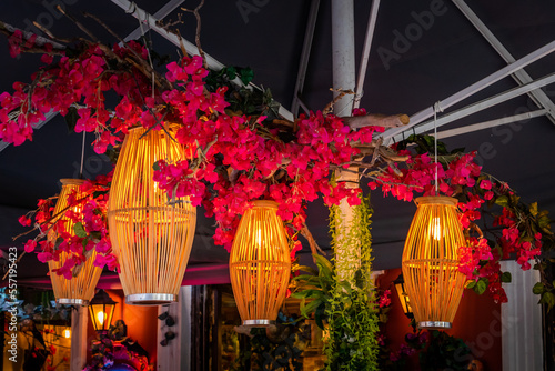 Light fixtures decorated with flowers in a restaurant in a city in Greece