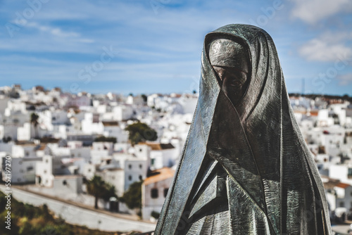 A monument of a black nun in a small hill town in Spain.