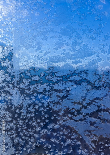 Frosty drawing on the window close-up in winter