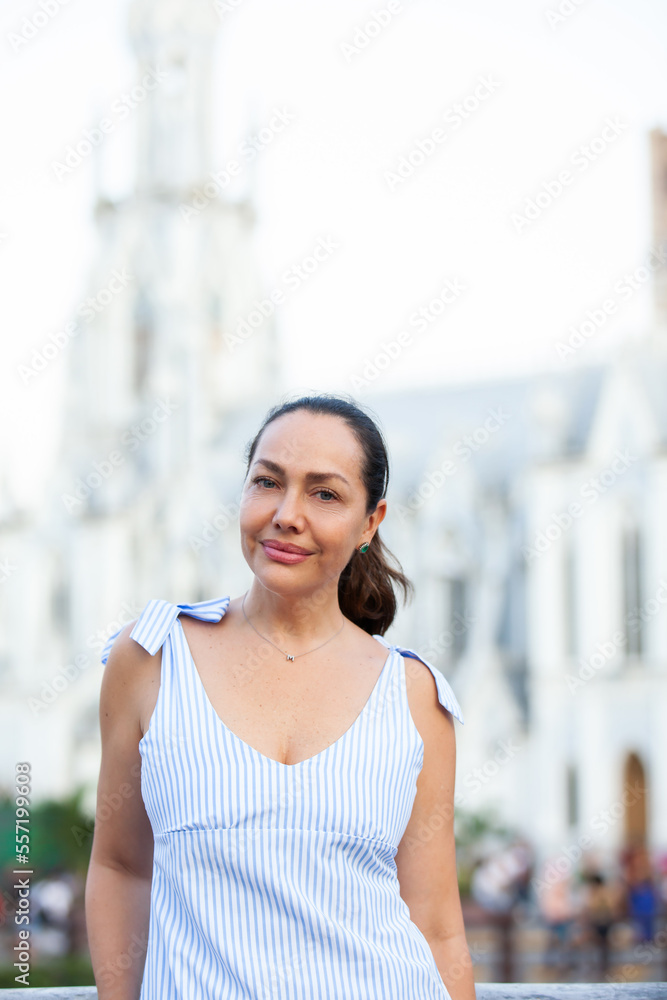 Beautiful tourist woman at the Ortiz Bridge with La Ermita church on background in the city of Cali in Colombia