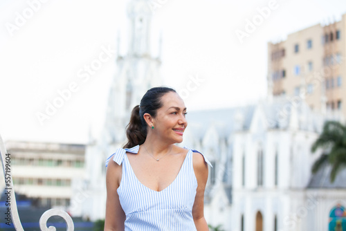 Beautiful tourist woman at the Ortiz Bridge with La Ermita church on background in the city of Cali in Colombia photo