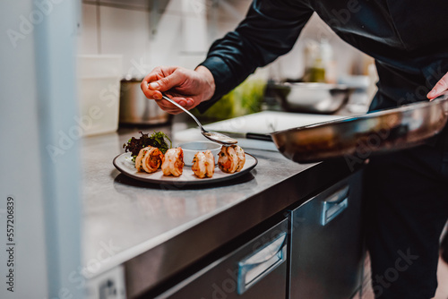 man chef cooking tasty shrimp on kitchen